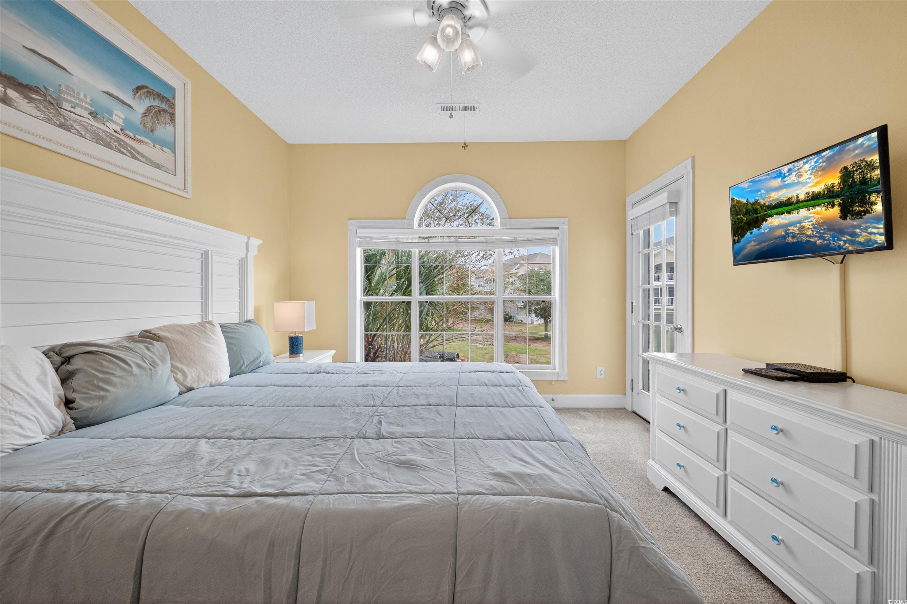 4673 Wild Iris Drive, Unit 204 Myrtle Beach, SC 29577 - Photo 12 of 20 Bedroom featuring light carpet, access to exterior