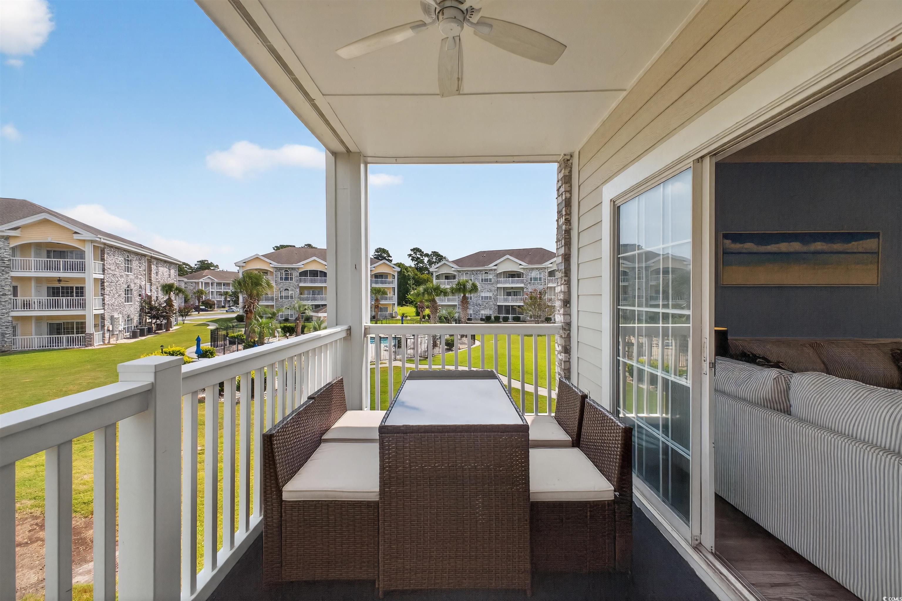 4673 Wild Iris Drive, Unit 204 Myrtle Beach, SC 29577 - Photo 14 of 20 Balcony with a ceiling fan and a sunroom