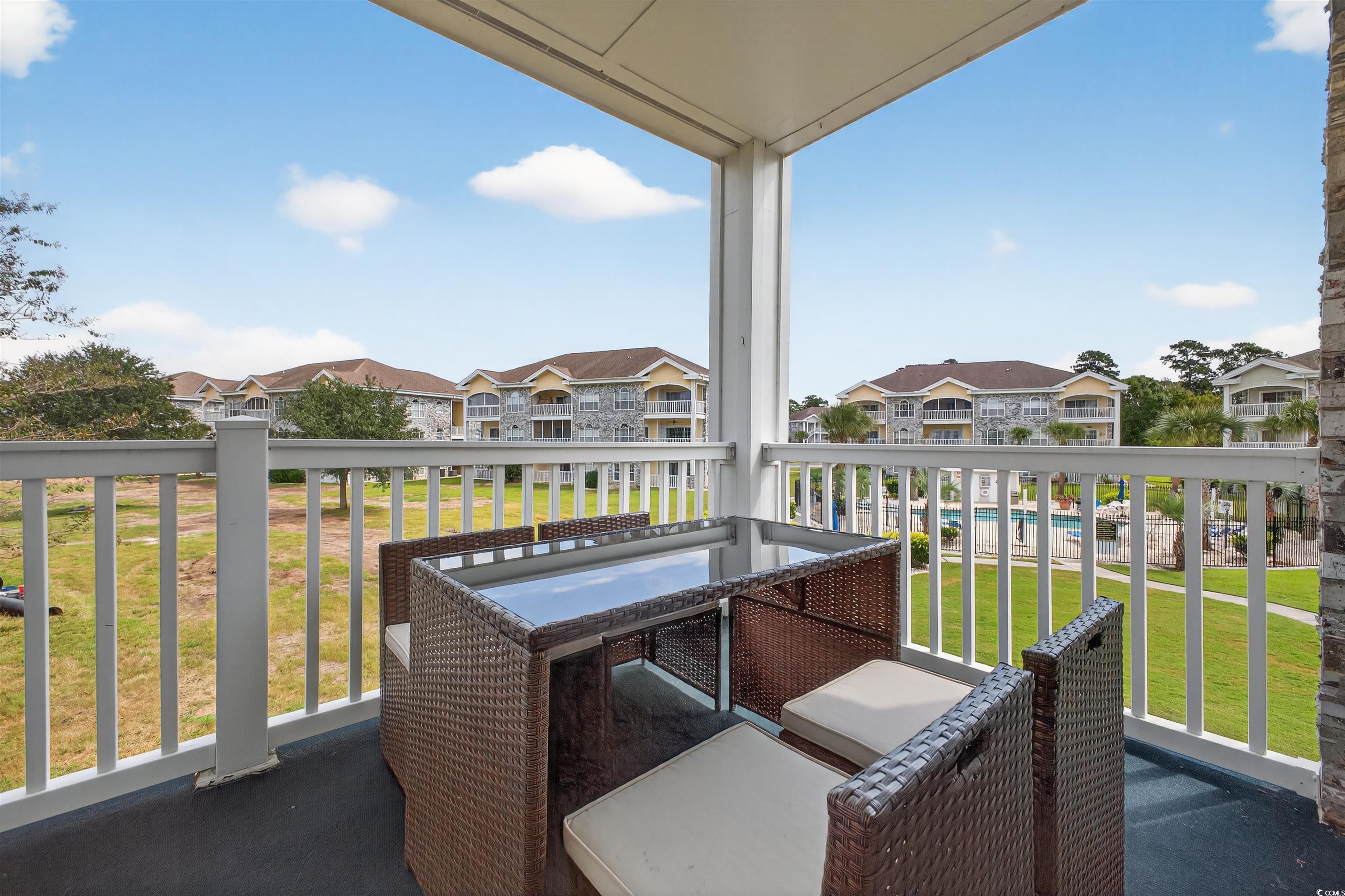 4673 Wild Iris Drive, Unit 204 Myrtle Beach, SC 29577 - Photo 15 of 20 Balcony featuring a sunroom