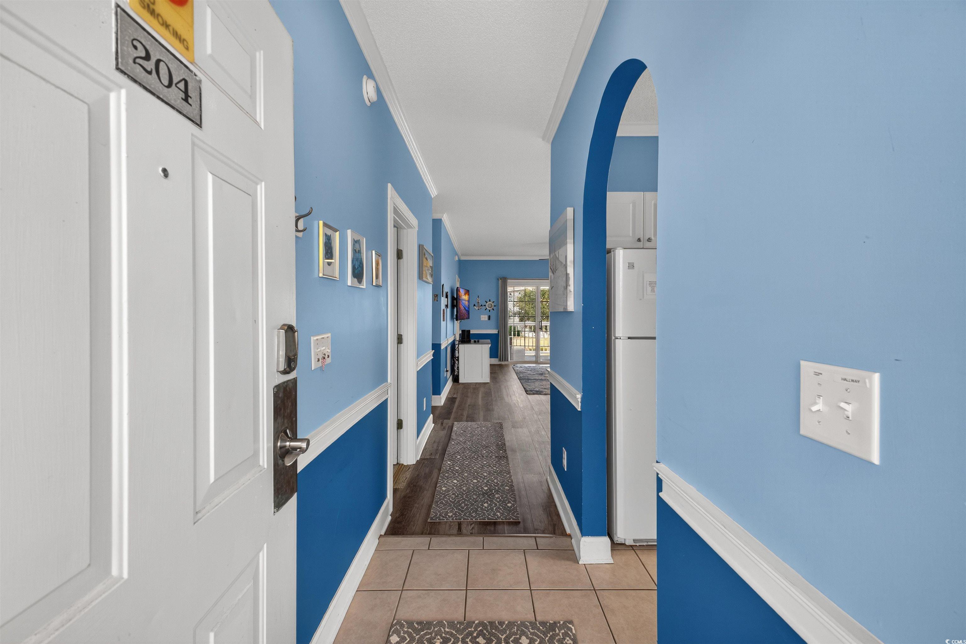 4673 Wild Iris Drive, Unit 204 Myrtle Beach, SC 29577 - Photo 5 of 20 Corridor featuring ornamental molding, light tile