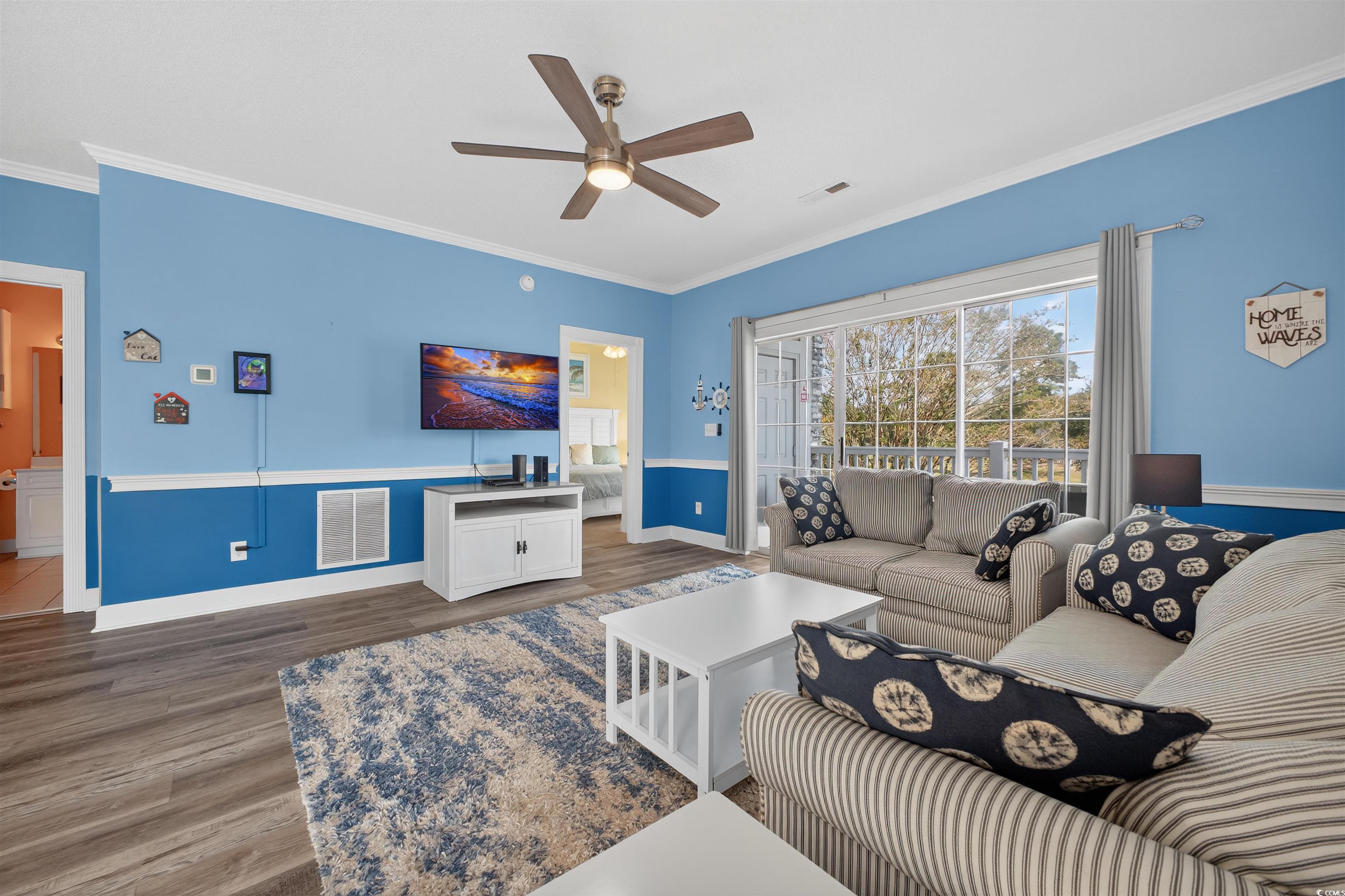 4673 Wild Iris Drive, Unit 204 Myrtle Beach, SC 29577 - Photo 7 of 20 Living area featuring crown molding, wood finished