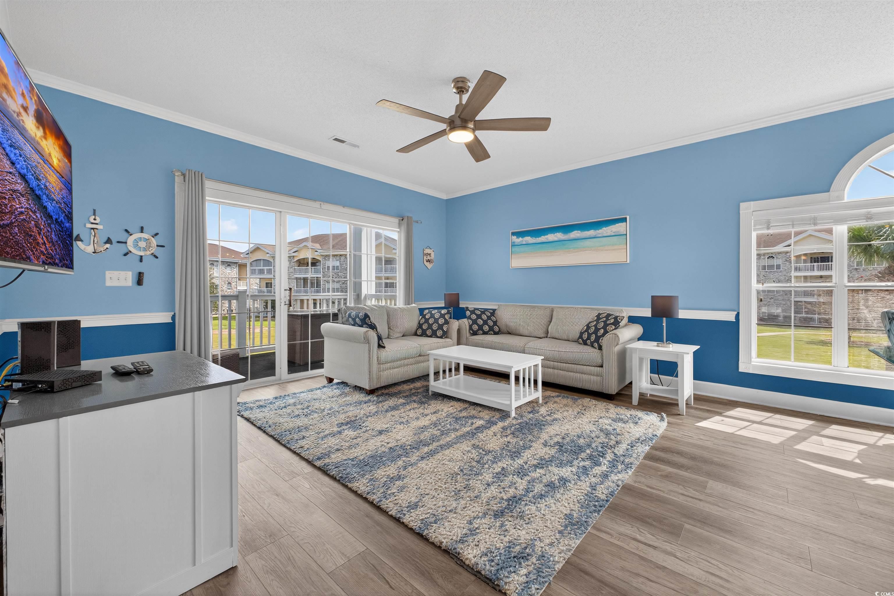4673 Wild Iris Drive, Unit 204 Myrtle Beach, SC 29577 - Photo 8 of 20 Living room with crown molding, wood finished floo