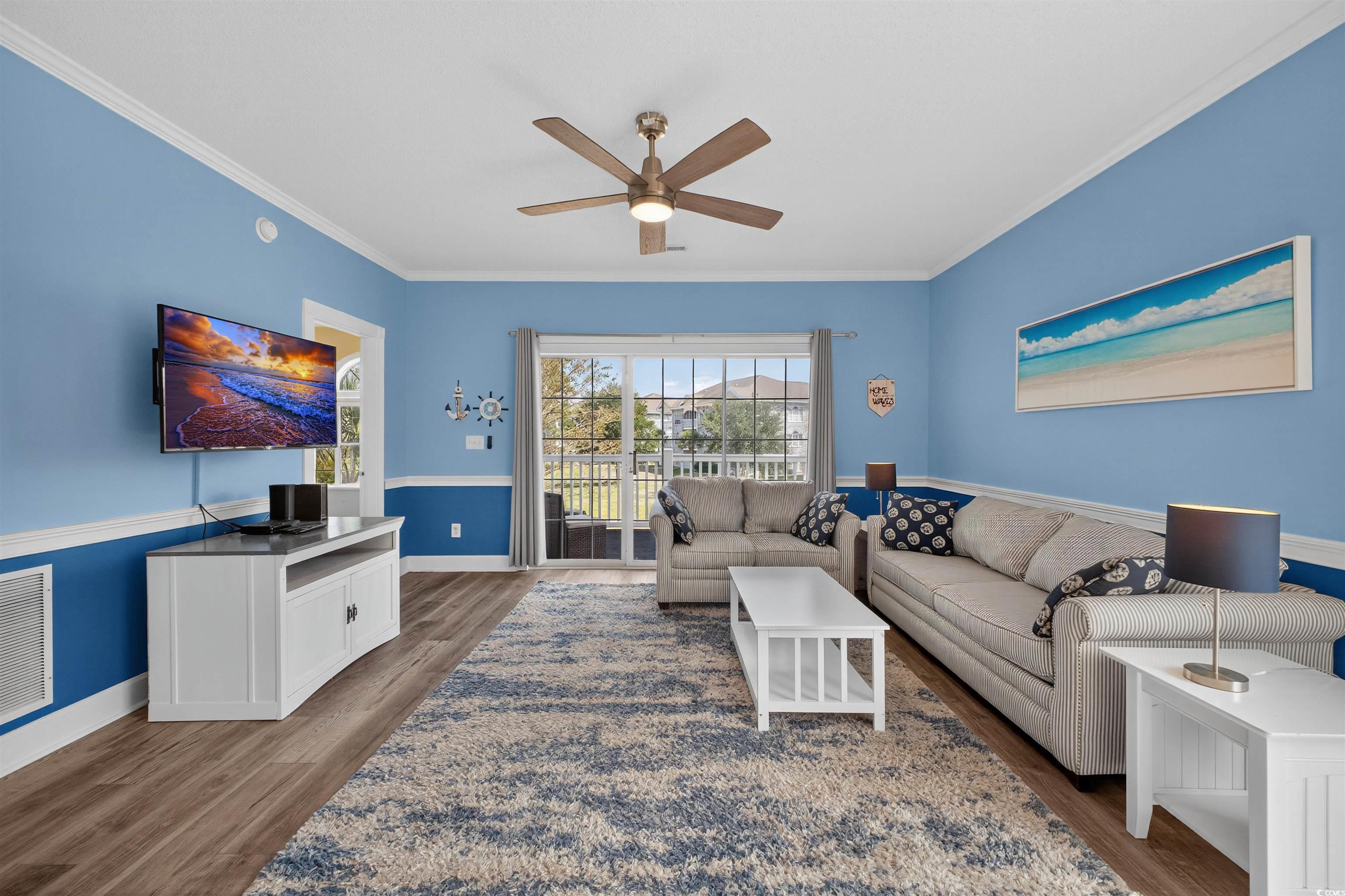 4673 Wild Iris Drive, Unit 204 Myrtle Beach, SC 29577 - Photo 9 of 20 Living room with crown molding, dark wood-type flo