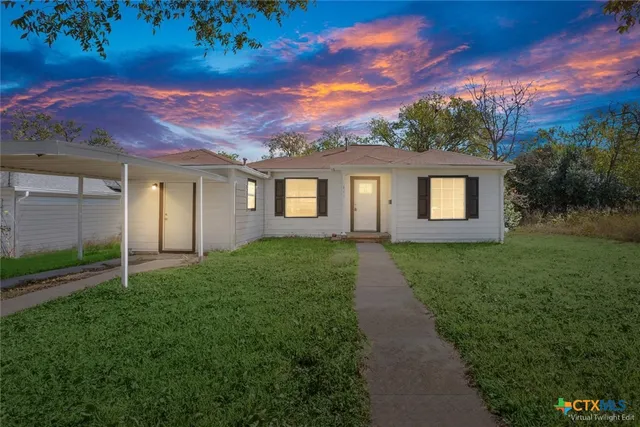a front view of a house with a yard