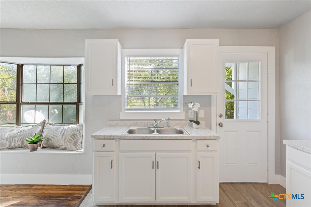 811 North 6th Street Temple, TX 76501 - Photo 11 of 23 a bathroom with a granite countertop sink and a window
