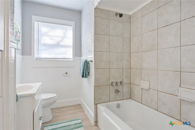 a living room with a rug and a window
