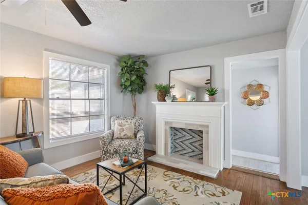 a living room with furniture and a fireplace