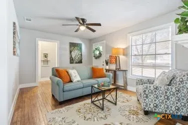 a living room with furniture and a large window