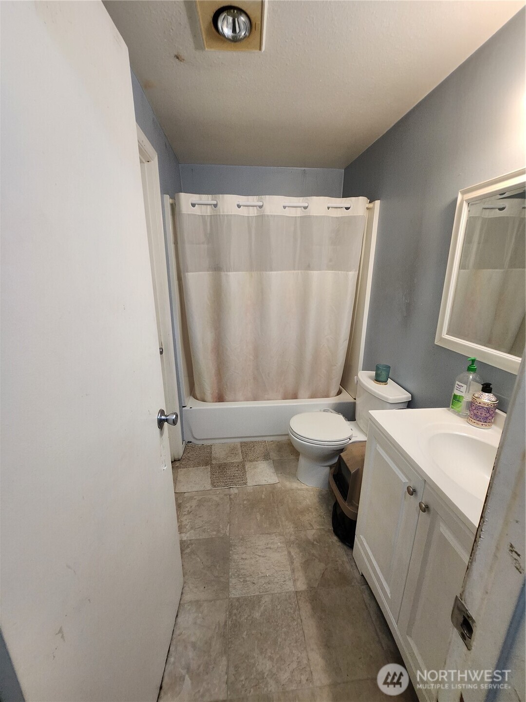 2019 Southwest 318th Place, Unit 4C Federal Way, WA 98023 - Photo 15 of 23 a bathroom with a sink a toilet and shower curtain
