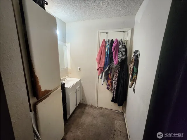 a view of a hallway with wooden floor and stairs