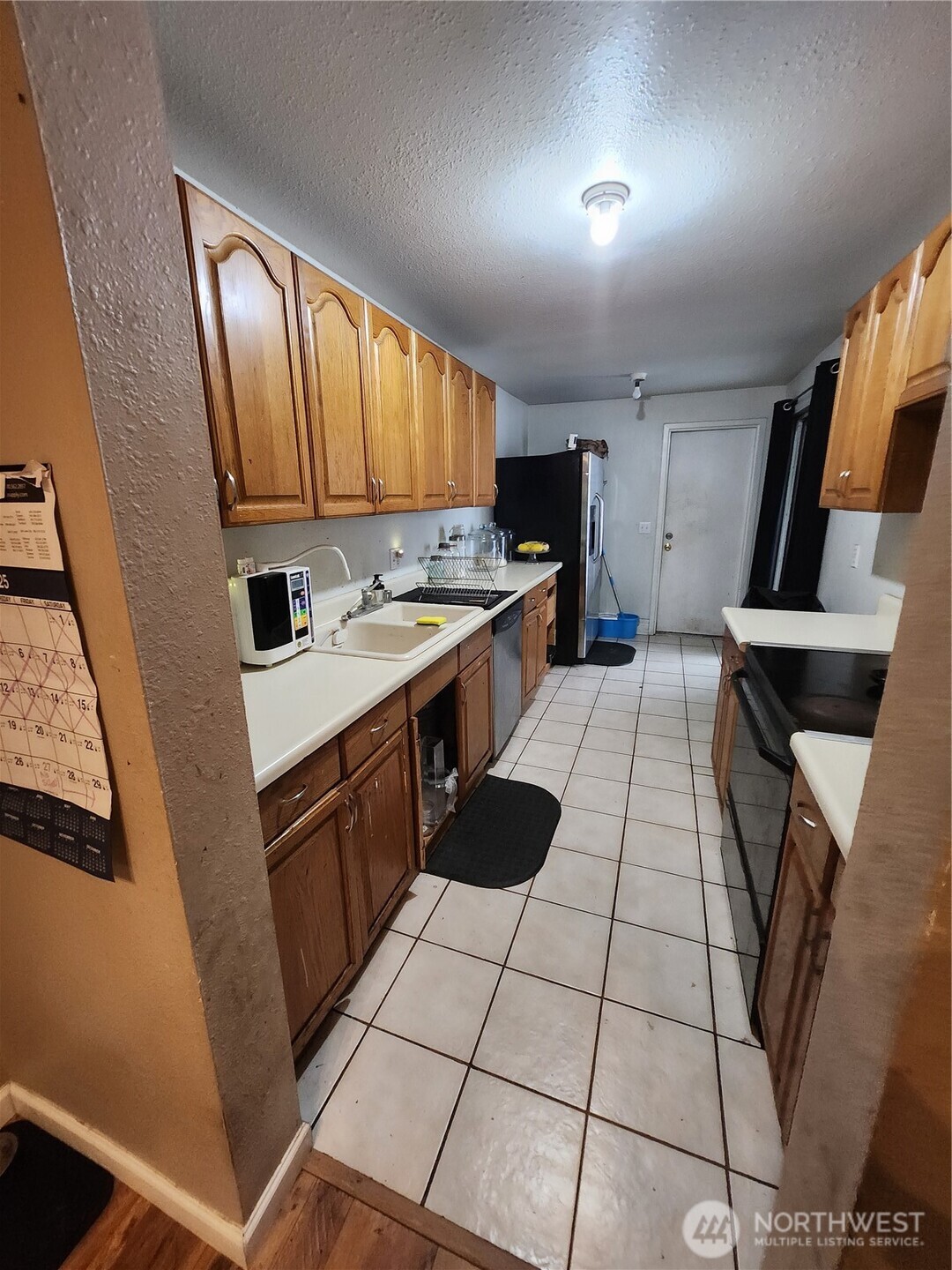2019 Southwest 318th Place, Unit 4C Federal Way, WA 98023 - Photo 4 of 23 a kitchen with a sink a stove cabinets and a window