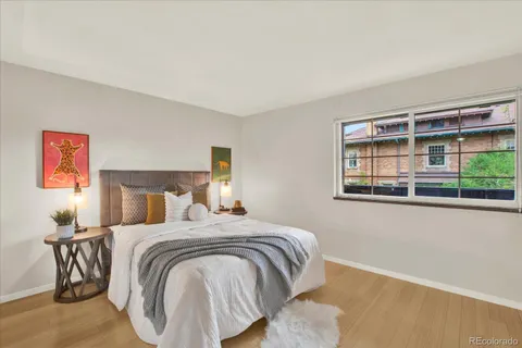 a bedroom with a bed and a large window