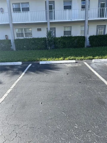 a view of a house with a yard and a garage