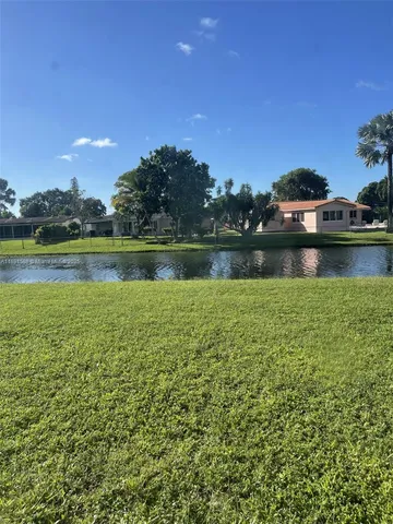 a view of a lake with houses in the background