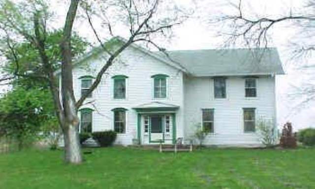 20478 Crosby Road Morrison, IL 61270 - Photo 1 of 7 a front view of a house with a yard and porch