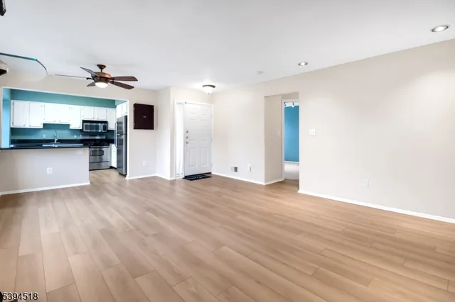 a view of a kitchen with a sink and a refrigerator