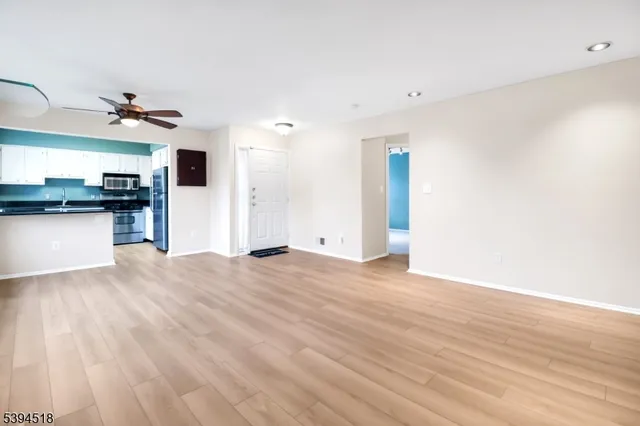 a view of a kitchen with a sink and a refrigerator