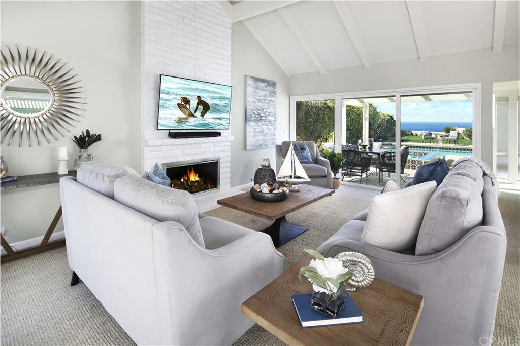 Living Room with Open-Beamed Ceilings and Fireplace with Amazing Ocean View