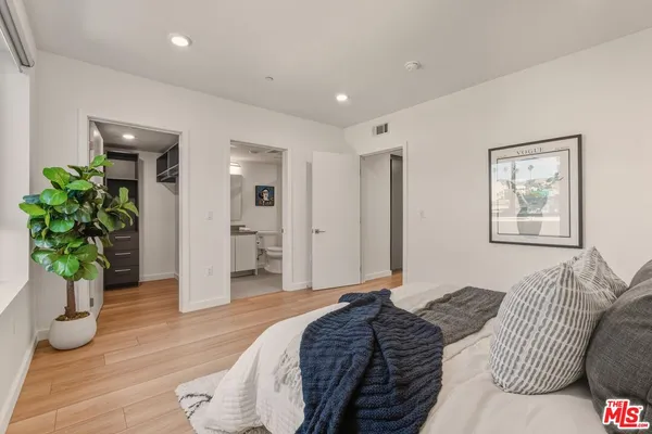 a bedroom with furniture and a potted plant