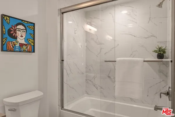 a bathroom with a shower and a toilet