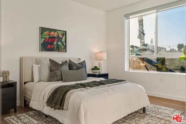 a bedroom with bed and a window with outer view