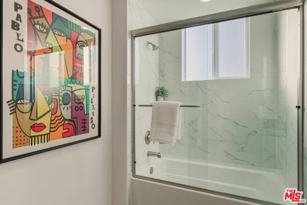 a bathroom with a window and a shower