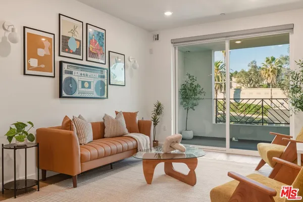 a living room with furniture and a large window