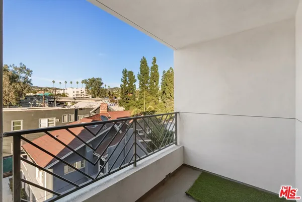a view of a balcony with chairs