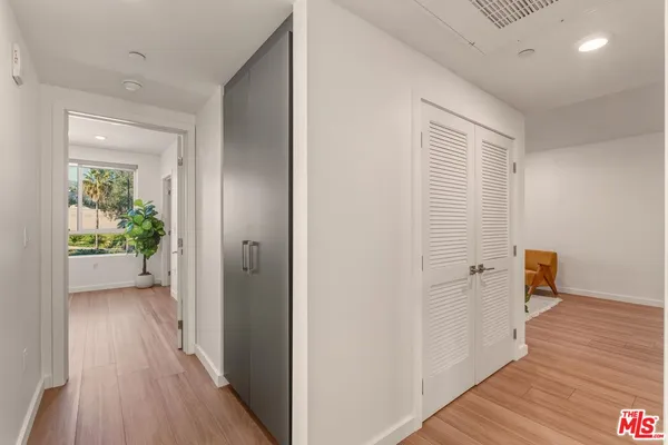 a view of a hallway with wooden floor