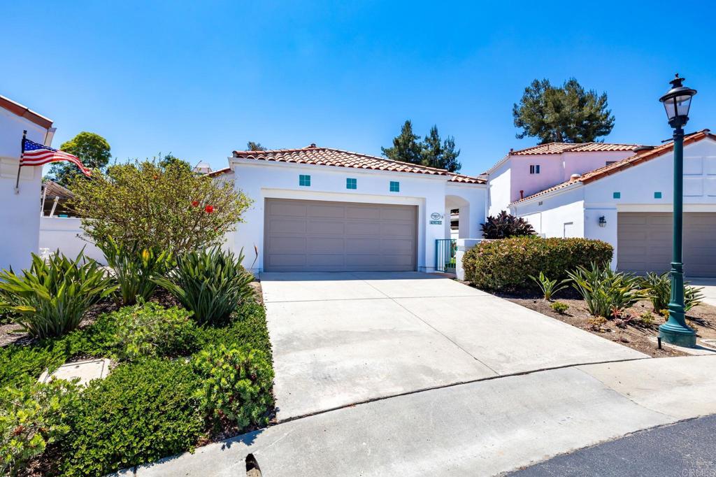 4939 Tilos Way Oceanside, CA 92056 - Photo 8 of 49 a front view of a house with a yard and garage