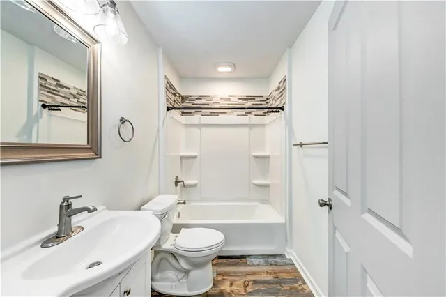 a bathroom with a toilet a sink and a bathtub