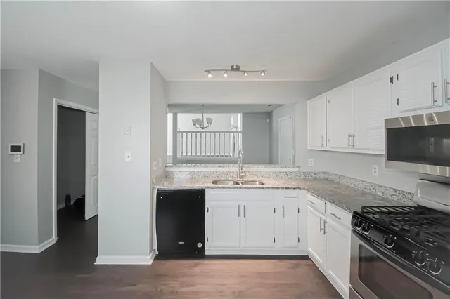 a kitchen with a sink stove and cabinets
