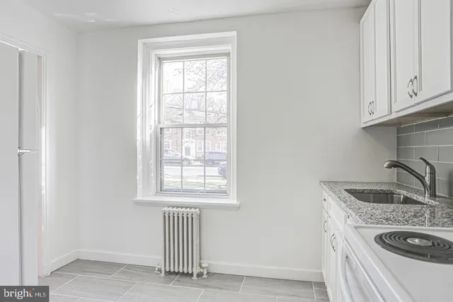 a kitchen with granite countertop a sink and a window