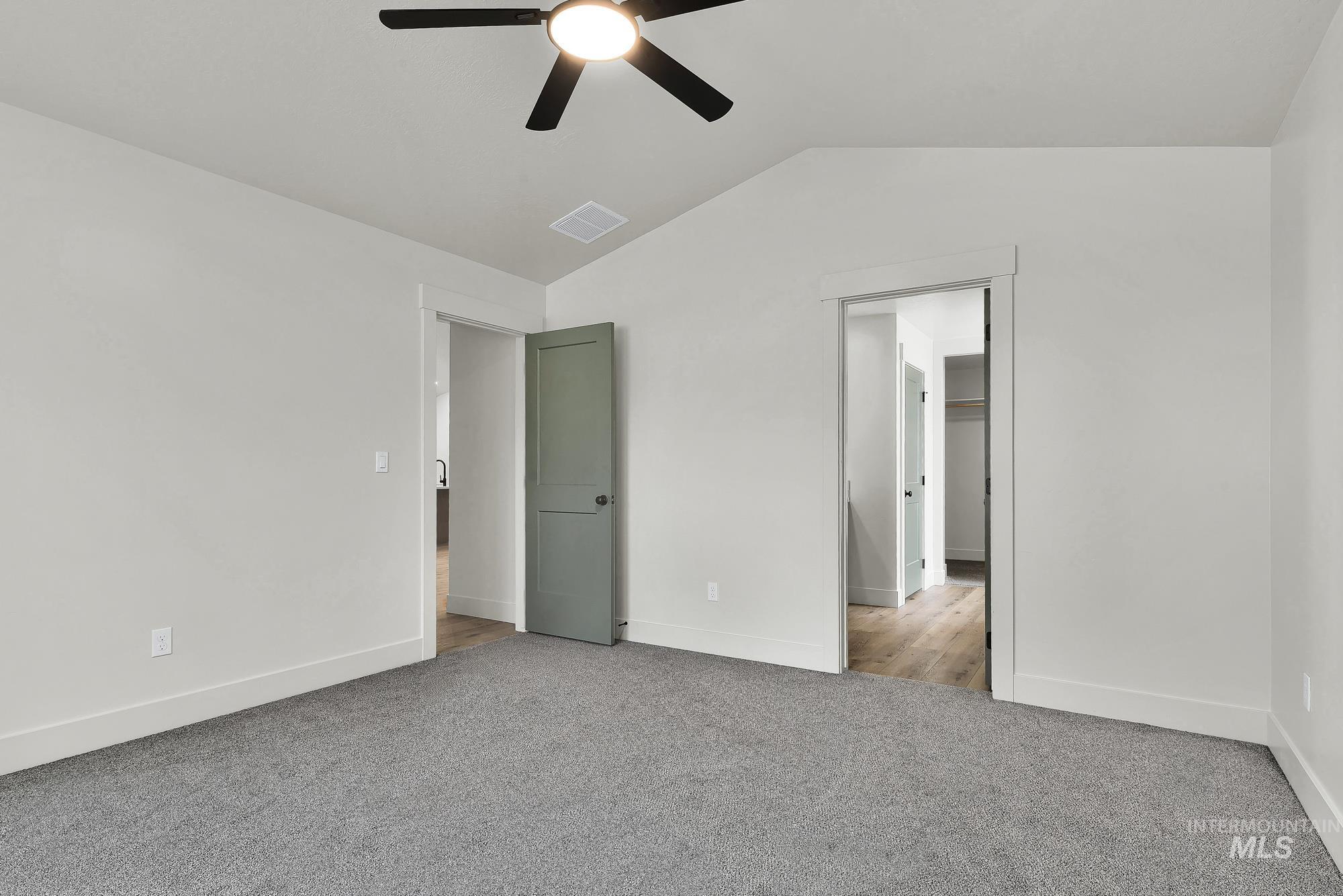 1130 Velvet Loop Wilder, ID 83676 - Photo 19 of 35 Carpeted room featuring a vaulted ceiling and a ceiling fan with integrated lighting
