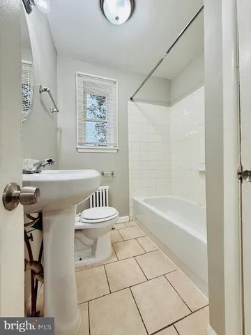 a bathroom with a bathtub a sink and a mirror