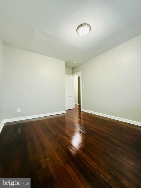 4809 Wilern Avenue Baltimore, MD 21215 - Photo 13 of 18 an empty room with wooden floor and windows