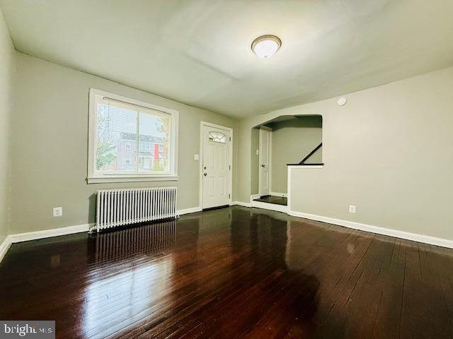 4809 Wilern Avenue Baltimore, MD 21215 - Photo 3 of 18 an empty room with wooden floor and windows