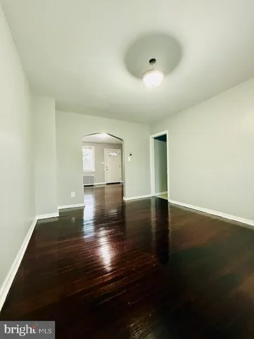 a view of room with window and wooden floor