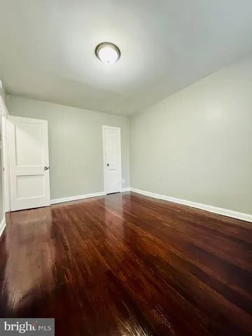 an empty room with wooden floor