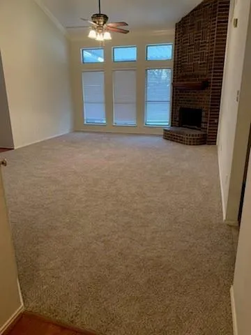 a view of an empty room with a fireplace