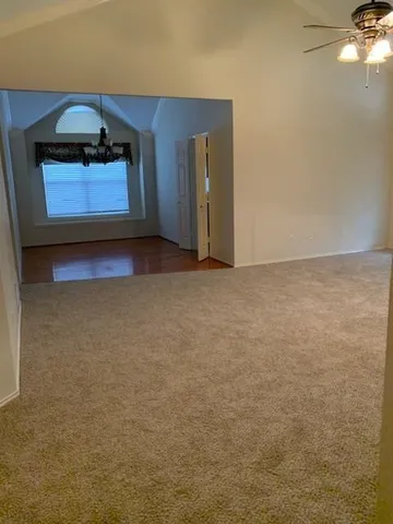 a view of an empty room and cabinet with a fireplace