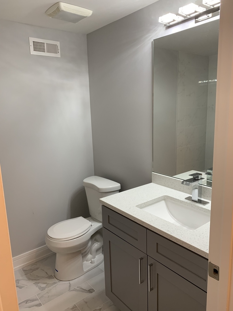 3706 North Drake Avenue, Unit G Chicago, IL 60618 - Photo 11 of 23 a bathroom with a sink a toilet