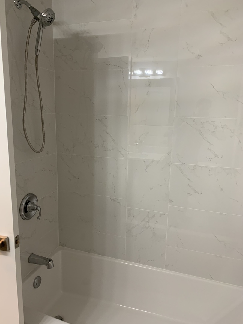 3706 North Drake Avenue, Unit G Chicago, IL 60618 - Photo 12 of 23 a bathroom with a shower and a bathtub