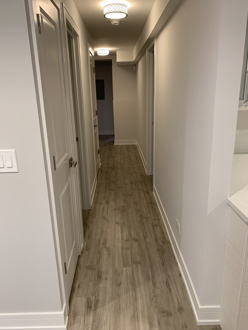 3706 North Drake Avenue, Unit G Chicago, IL 60618 - Photo 6 of 23 a view of hallway with wooden floor