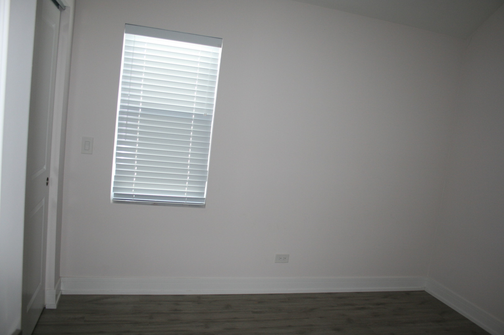 3706 North Drake Avenue, Unit G Chicago, IL 60618 - Photo 10 of 23 a view of an empty room with wooden floor and a window