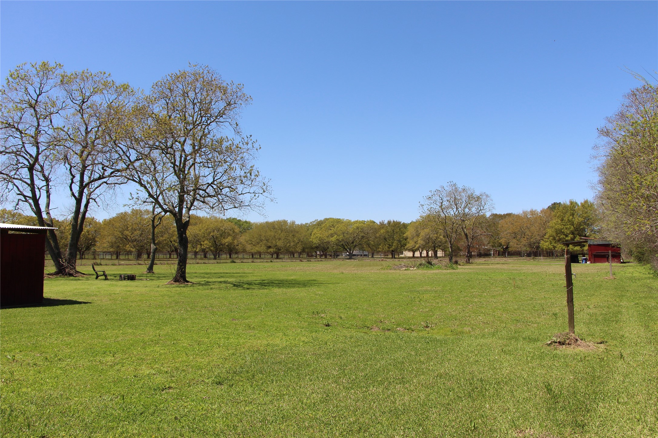 12710 Dannhaus Road Needville, TX 77461 - Photo 6 of 24 Field behind barn. Work shop at back of property. Water and electric