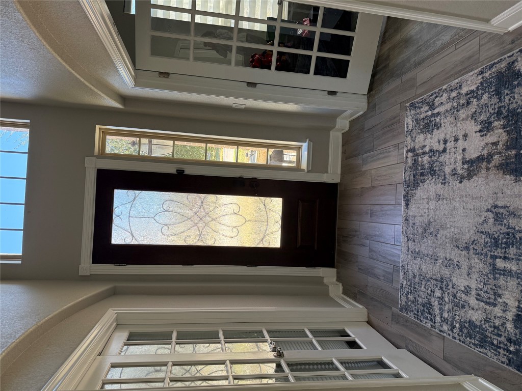 Undisclosed Address Leander, TX 78641 - Photo 2 of 8 Entrance foyer featuring french doors, dark wood finished floors, and plenty of natural light