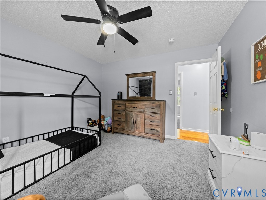 6712 Hedges Road Richmond, VA 23224 - Photo 22 of 34 Spacious room featuring light gray walls and plush