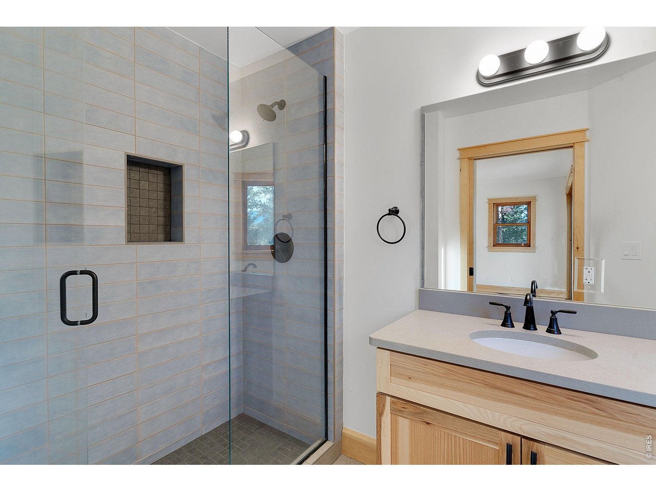 3725 Ridge Road Nederland, CO 80466 - Photo 43 of 44 a bathroom with a shower sink vanity and mirror