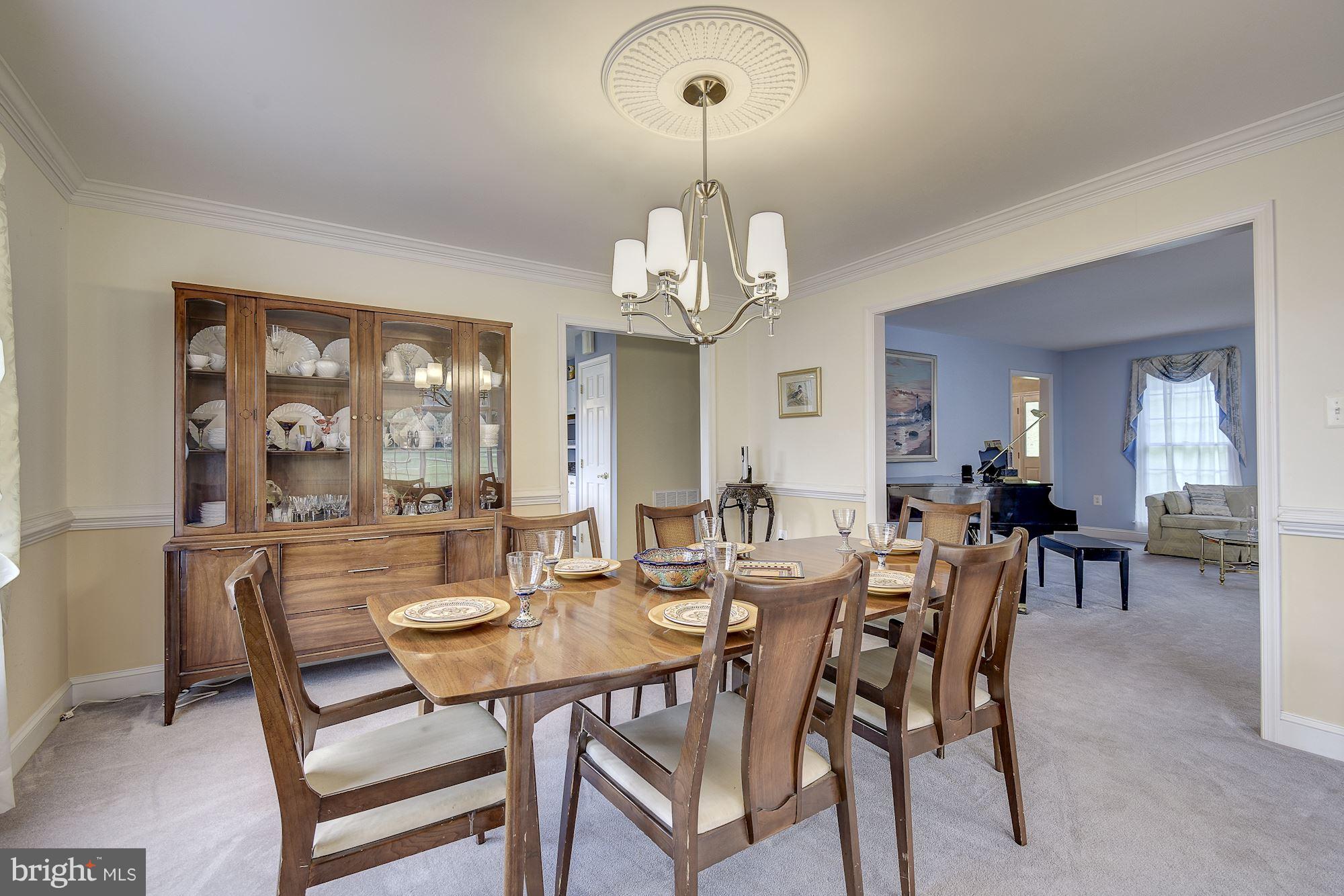 10920 Ward Road Dunkirk, MD 20754 - Photo 12 of 63 a view of a dining room with furniture and chandelier